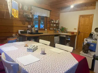 a kitchen with a table with a table cloth on it at Roubenka v Posázaví in Zbizuby