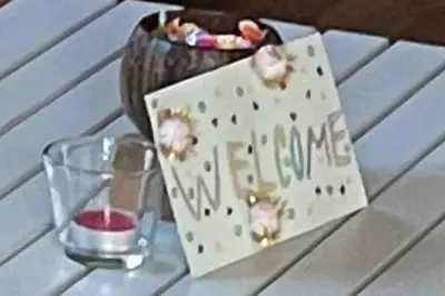 a box on a table with a candle and a glass at Roubenka v Posázaví in Zbizuby