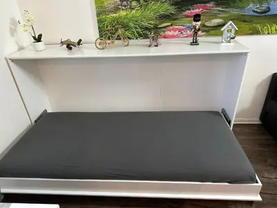 a white shelf with a black bed in a room at O2 Aréna -PVA expo - Tomy Apartment -Praha in Prague