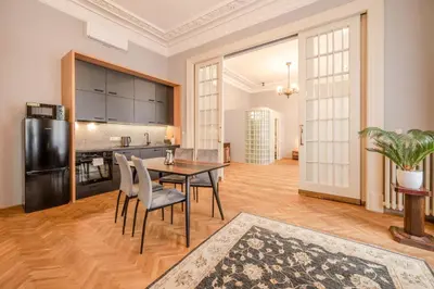 a kitchen and dining room with a table and chairs at Palace Petrarca in Prague