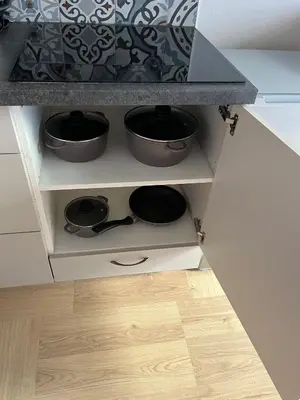 a kitchen cabinet with three pots on top of a wooden floor at Palace Petrarca in Prague