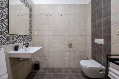 a bathroom with a toilet and a sink at Palace Petrarca in Prague