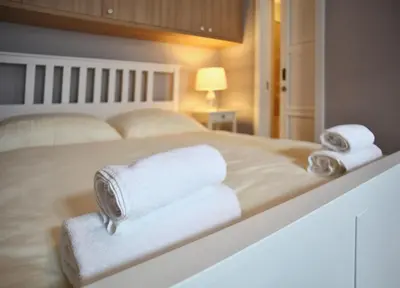 a bedroom with two towels on a bed at Lovely Lila apartment in Prague