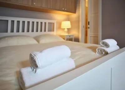 a bedroom with a bed with towels on it at Grey cozy apartment in Prague