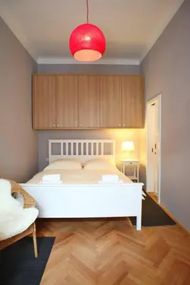 a bedroom with a white bed and a red light at Grey cozy apartment in Prague