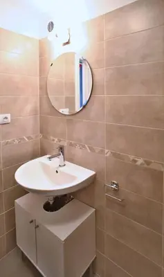 a bathroom with a sink and a mirror at Grey cozy apartment in Prague