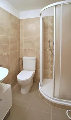 a bathroom with a toilet and a shower at Grey cozy apartment in Prague