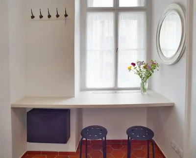 a kitchen with two stools and a counter with a window at Grey cozy apartment in Prague