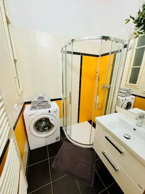 a bathroom with a washing machine and a washer at Apartments by Jacob in Prague