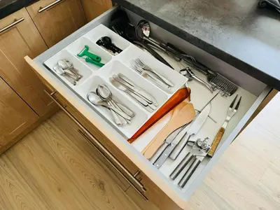 a drawer filled with utensils on a kitchen counter at Apartments by Jacob in Prague