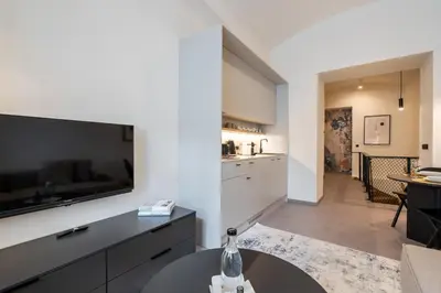 a bedroom with a bed and a picture on the wall at HONEST Karlin in Prague
