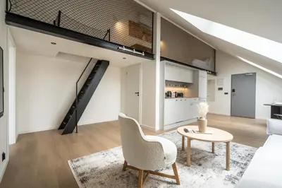 a living room with a tv and a table at HONEST Karlin in Prague