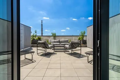 a patio with a table and chairs on a balcony at HONEST Ricany in Ricany