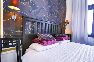 a bedroom with a bed with two pillows on it at Two-bedroom Haven In The Old Town in Prague