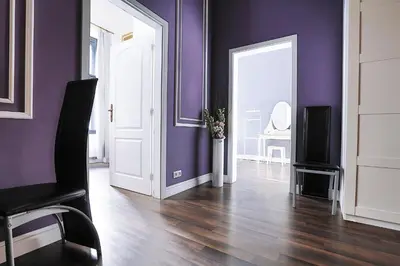 a living room with purple walls and a door at Two-bedroom Haven In The Old Town in Prague