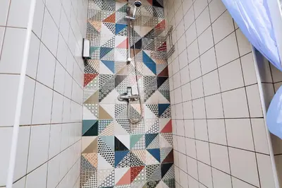 a shower with a mosaic wall in a bathroom at Two-bedroom Haven In The Old Town in Prague