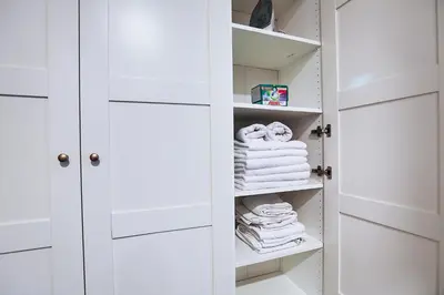 a white closet with white doors and towels at Two-bedroom Haven In The Old Town in Prague