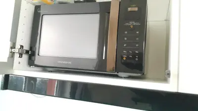 a microwave oven sitting on top of a shelf at Bastien Studio near Airport in Prague