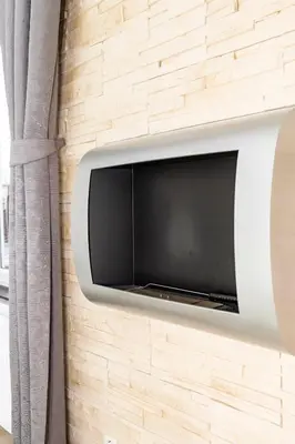 a television mounted on a brick wall at Bastien Studio near Airport in Prague