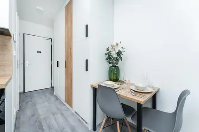 a dining room with a table and chairs at Rentero MyMozart Apartments Prague in Prague