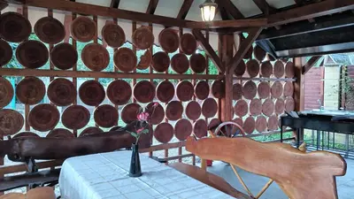 a room with a table and a wall of wine barrels at Ardilla in Lhota