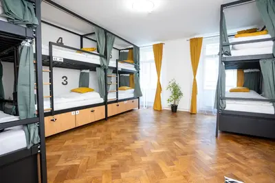 a kitchen with a black stove with a towel on the oven at White Wolf House Hostel & Apartments in Prague