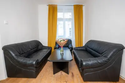 a bedroom with two bunk beds with yellow curtains at White Wolf House Hostel & Apartments in Prague