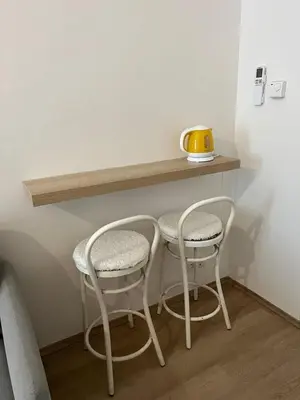 two chairs and a table in a room at Apartmány Soukenická in Prague