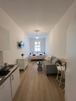 a living room with a couch and a bed at Apartmány Soukenická in Prague