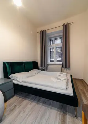 a large bed in a room with a window at Apart Comfort in Prague