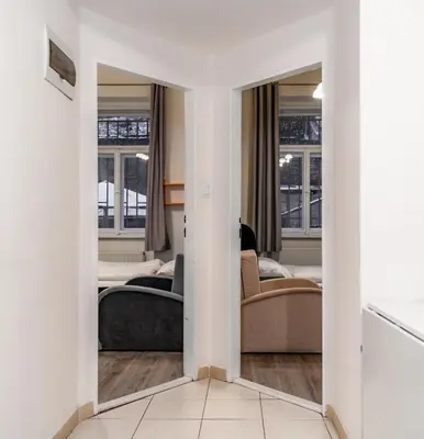 a living room with a mirror and a couch at Apart Comfort in Prague
