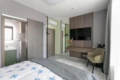 a bedroom with a bed and a sink and a television at LUONG Europe Apartments in Prague
