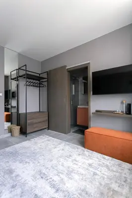 a living room with a bed and a tv at LUONG Europe Apartments in Prague