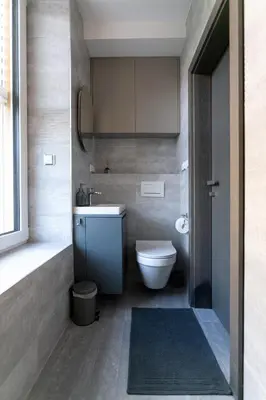 a bathroom with a toilet and a sink at LUONG Europe Apartments in Prague
