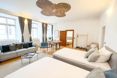 a living room with a couch and a table at Best Price & Location - Historic Square Residency in Prague