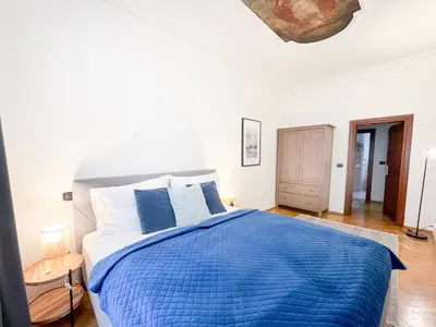 a bedroom with a bed with a blue blanket at Best Price & Location - Historic Square Residency in Prague