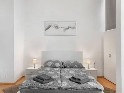 a white bedroom with a bed and two night stands at Apartment Old Town home-4 by Interhome in Prague