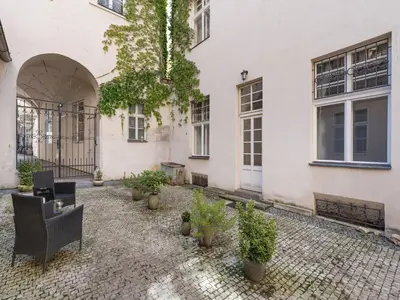a courtyard of a building with chairs and potted plants at Apartment Old Town home-4 by Interhome in Prague