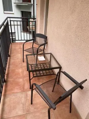 two chairs and a table on a balcony at Large 3 bedroom family apartment close to the river in Prague