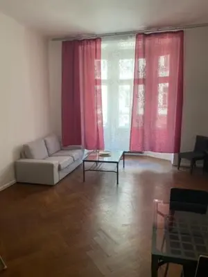 a living room with a white couch and red curtains at Large 3 bedroom family apartment close to the river in Prague