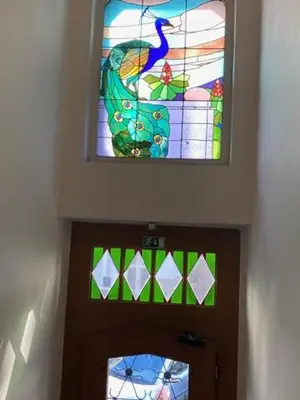 a stained glass window above the door of a church at Large 3 bedroom family apartment close to the river in Prague