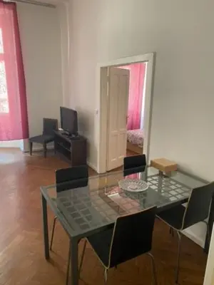a dining room with a glass table and chairs at Large 3 bedroom family apartment close to the river in Prague