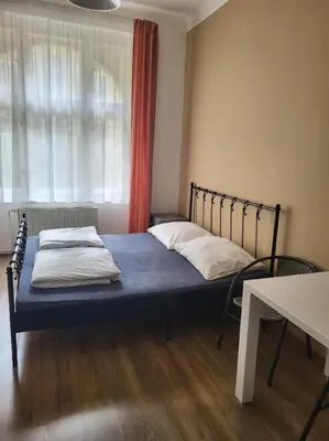 a bedroom with a bed with a blue mattress and a window at Pension Sunflower in Prague