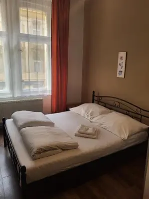 a bedroom with a bed with a tray on it at Pension Sunflower in Prague
