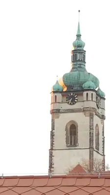 a tower with a clock on top of a building at Dům V Podzámčí in Mělník