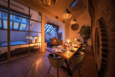 a dining room with a long table and chairs at 5BR+2Bath Old Town Industrial Penthouse, A/C in Prague