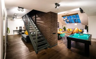 a living room with a pool table and a brick wall at 5BR+2Bath Old Town Industrial Penthouse, A/C in Prague