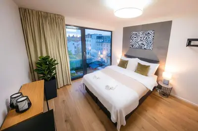 a bedroom with a large bed and a large window at 5BR+2Bath Old Town Industrial Penthouse, A/C in Prague