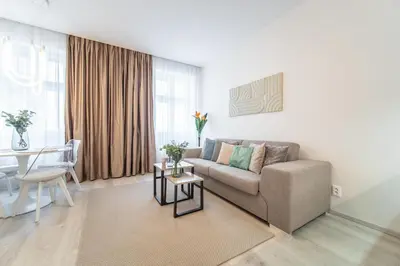 a living room with a couch and a table at A Prague Apartment - Old Town in Prague