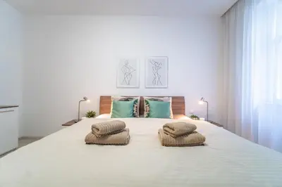 a bedroom with a large bed with two pillows on it at A Prague Apartment - Old Town in Prague